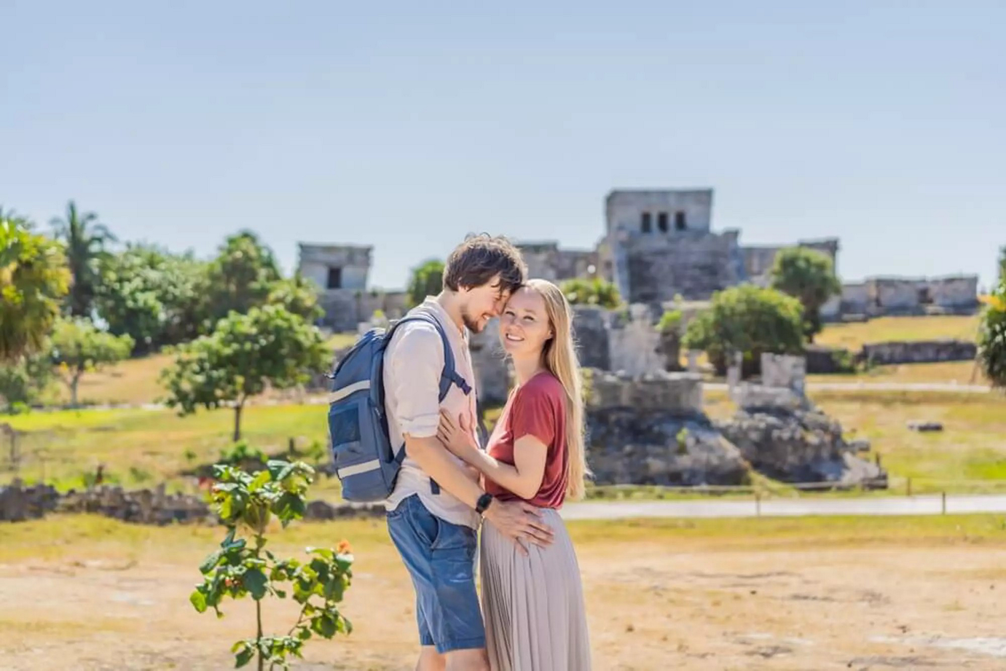 A couple poses in front of Tulum’s ruins on Valentine’s Day in Mexico.