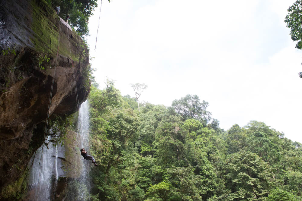 A woman enjoys the best waterfall rappelling in Costa Rica