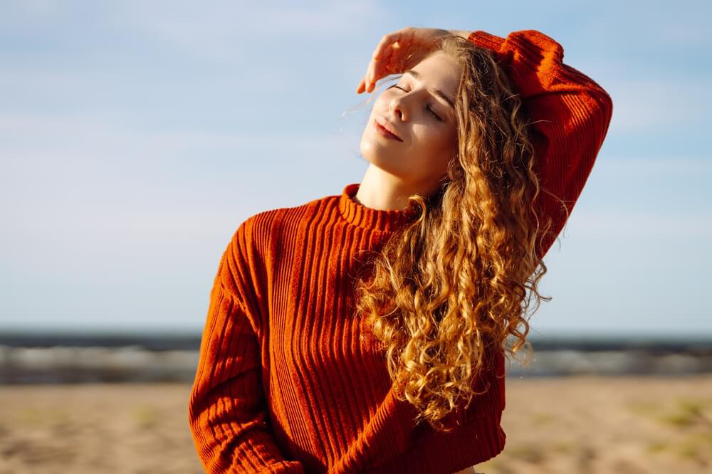 Hairstyles: A woman in a red jumper with her hair down