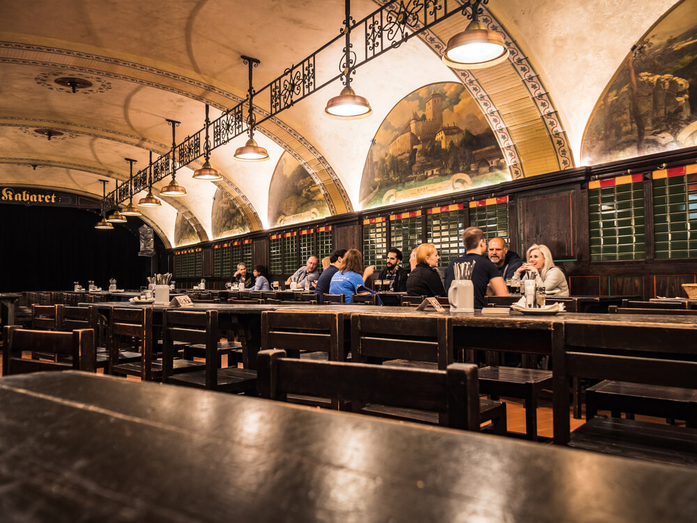 People drinking in a traditional beer hall in Prague