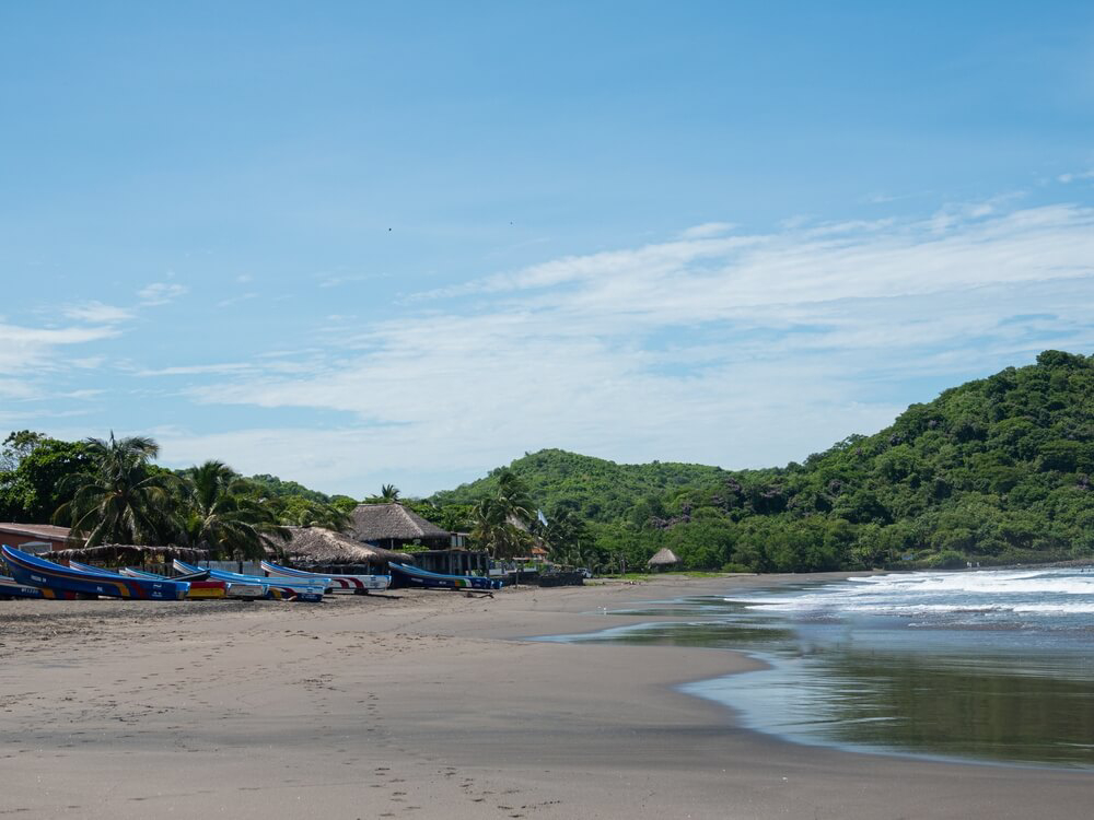 Kayaks and beach huts sit on the lush el Tránsito beach