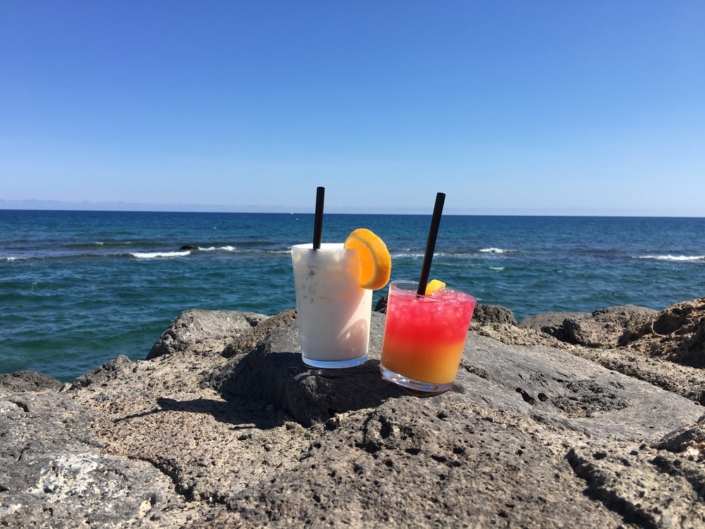 Cocktails resting on rocks overlooking the sea in Fuerteventura