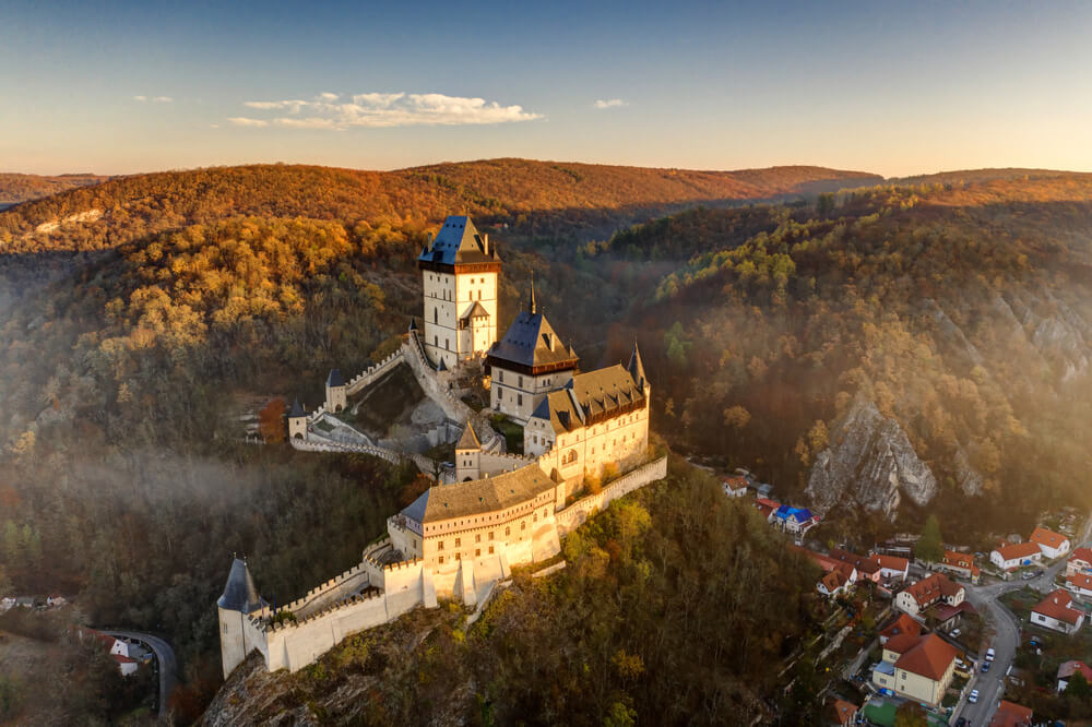 Karlstejn Castle: A view of the castle from above, surrounded by trees