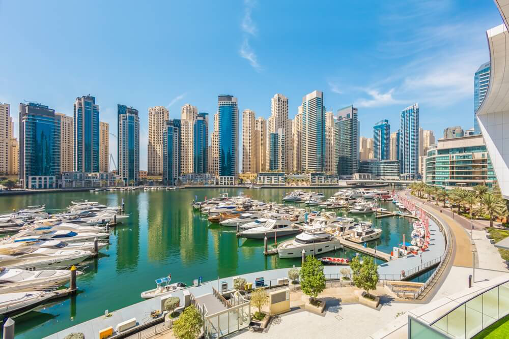 Dubai: A large harbour with yachts moored around the bay with skyscrapers in the background