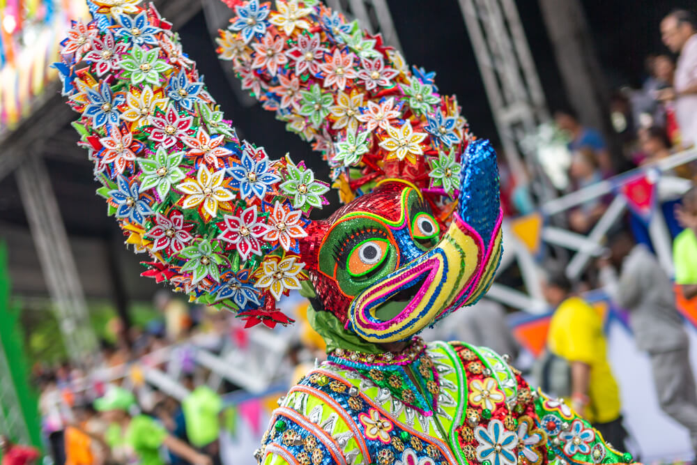 Carnival in the Dominican Republic: A man dressed in a diablo cojuelo carnival costume