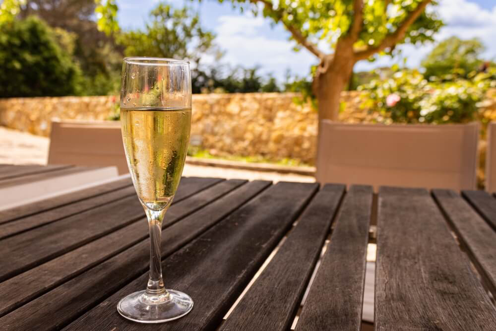 Cava tours in Barcelona: A glass of cava on a wooden table