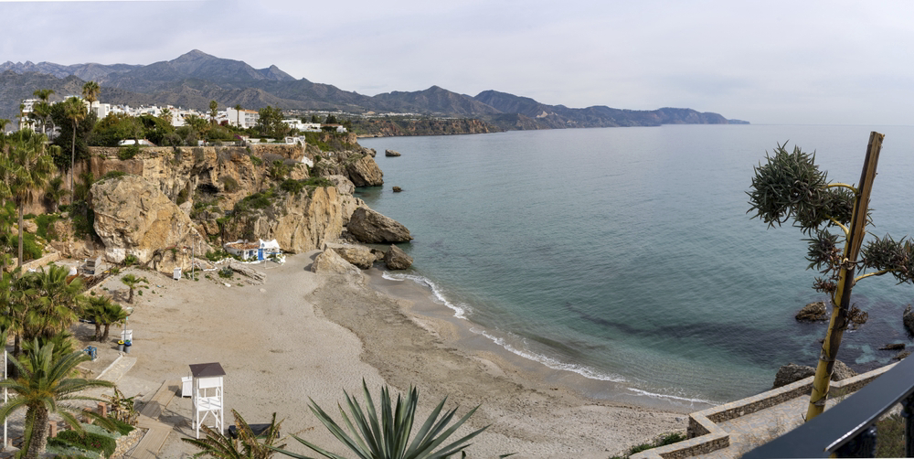 Costa del Sol Best Beaches: White sandy beach and cliffs with a C-shaped bay