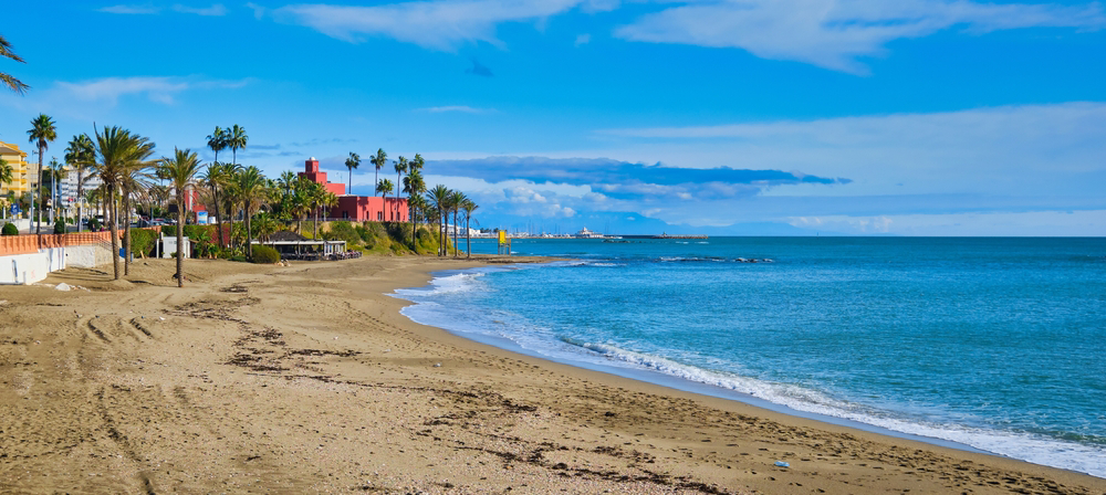 Costa del Sol Best Beaches: A dark sand beach lined with colourful houses