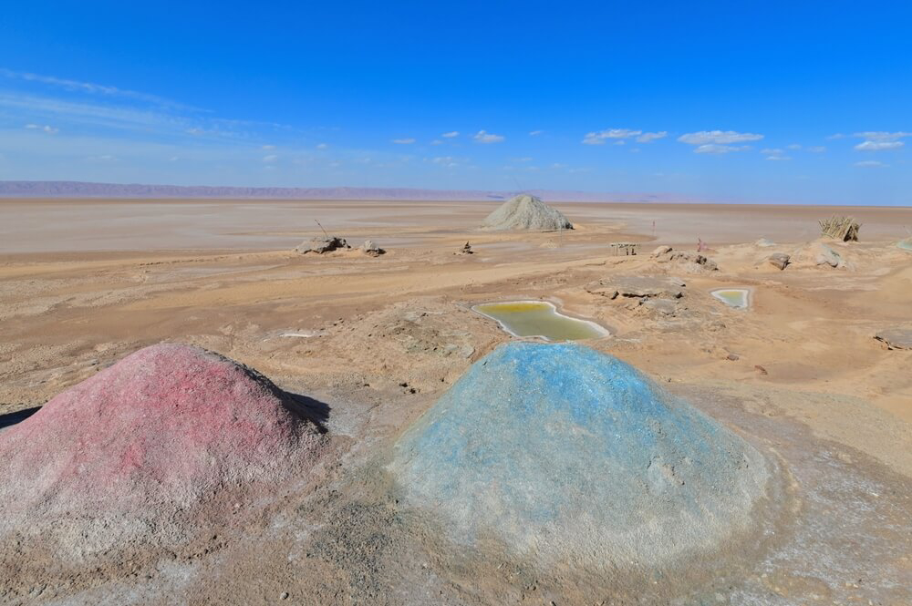 Desert safaris: pink and blue-tinged salt mounds sit before vast salt flats