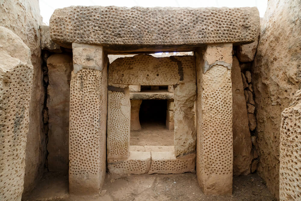 Famous Archaeological Sites: A grey stone entrance way with carved blocks of stone