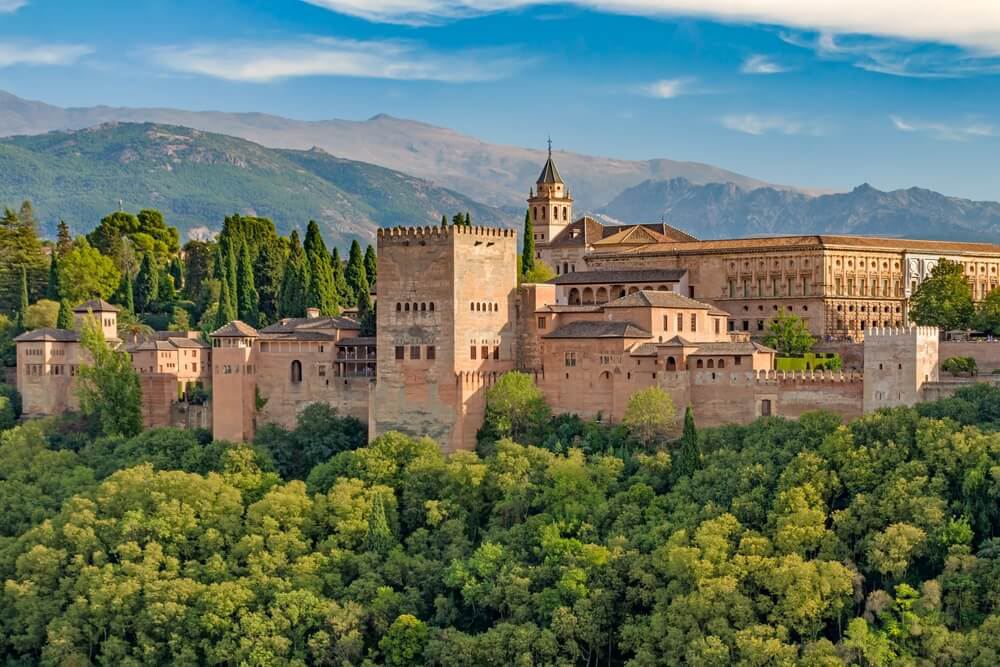 Alhambra: The red brick Alhambra fortress surrounded by trees