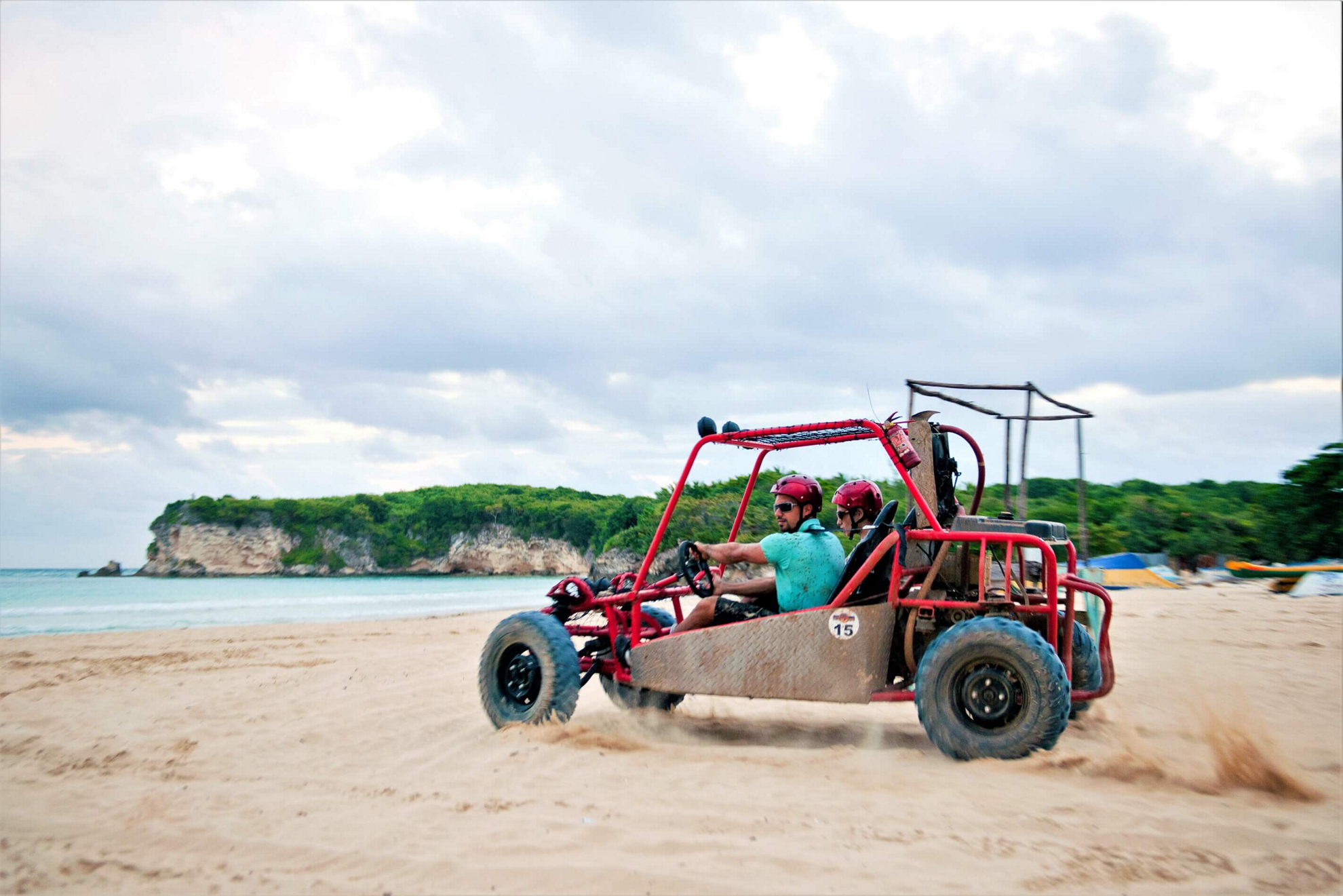 Father and son enjoy a family buggy adventure in Punta Cana on the sand
