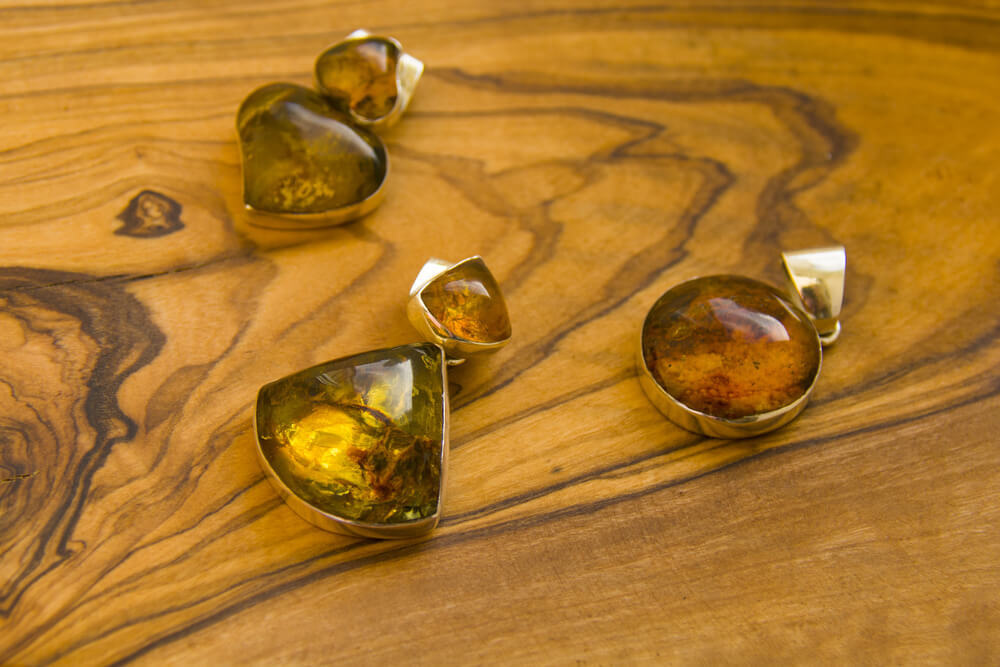 Amber jewelry, a souvenir from the Dominican Republic, sits on a wooden countertop