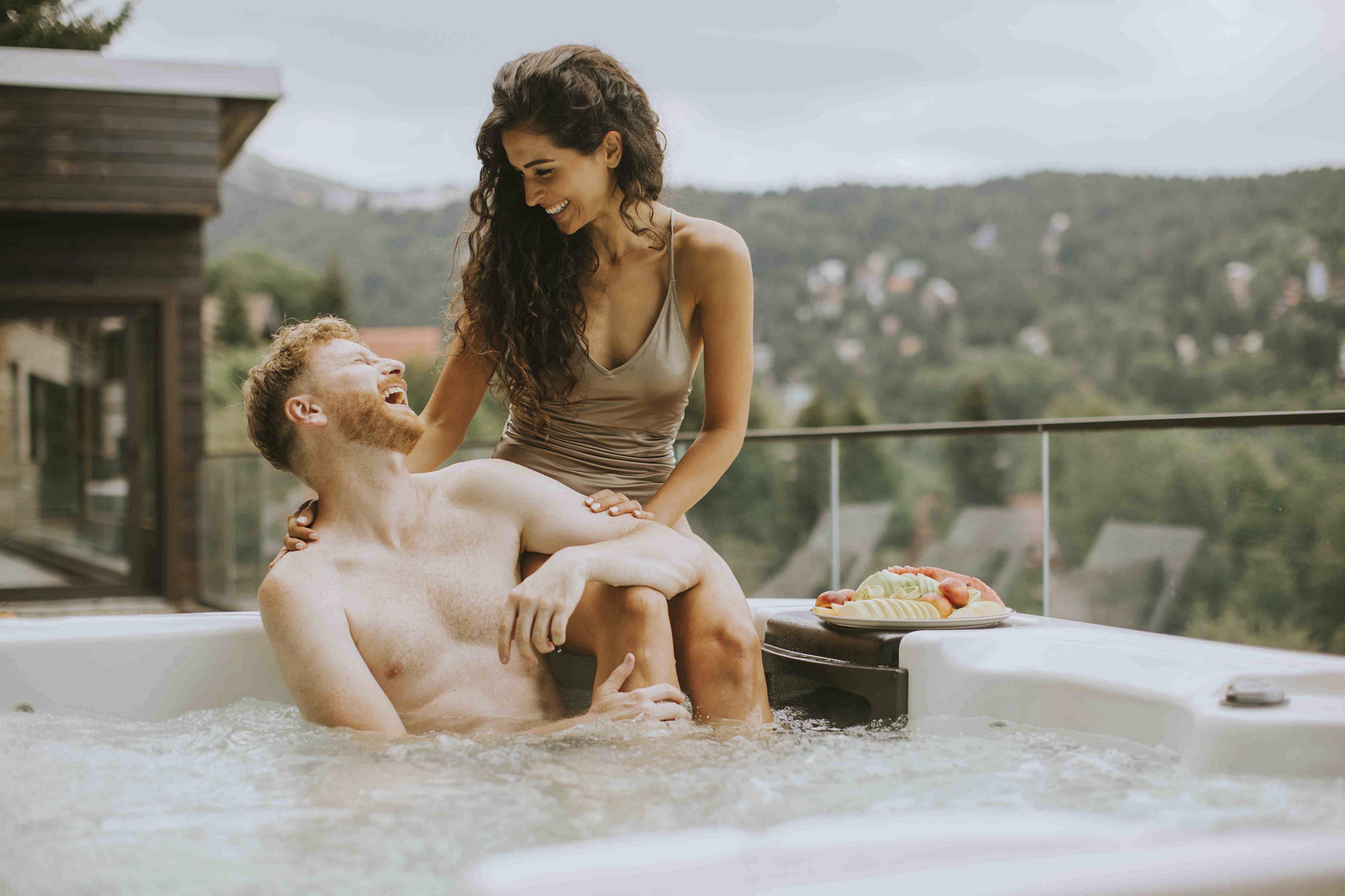 A couple sits in a private Jacuzzi on their spa honeymoon
