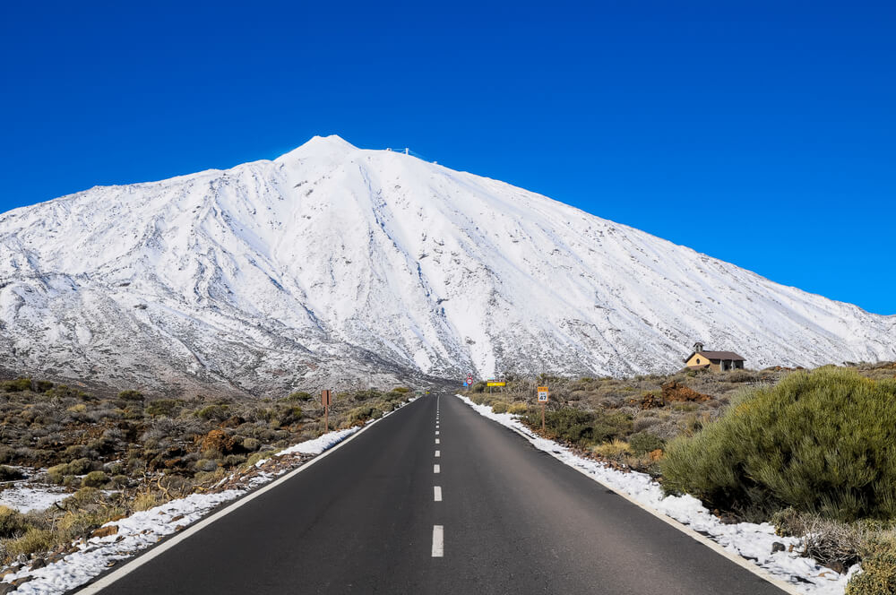 Snow on Teide: Teide volcano covered in snow and the road leading to the park