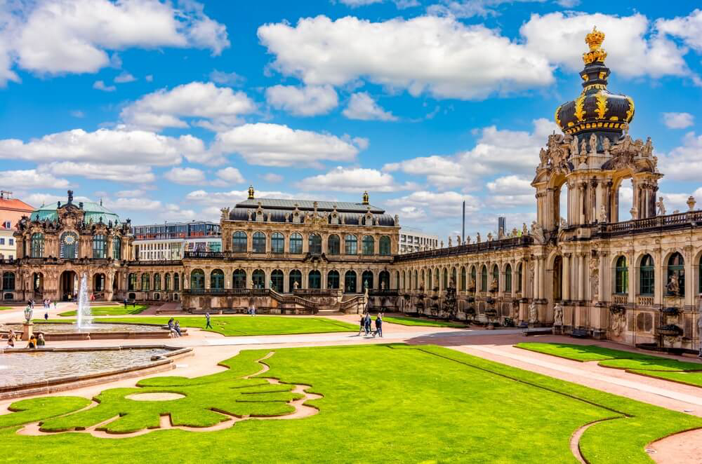 Zwinger Palace: An elaborate building with a golden dome and green grounds