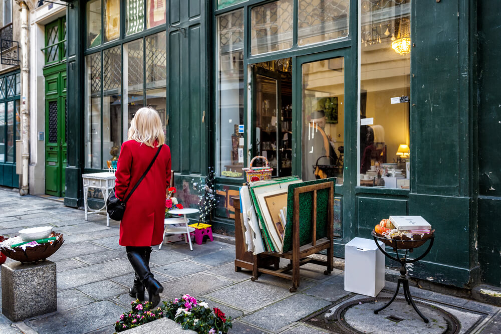Shopping: A woman in a red coat shopping on a street in Le Marais