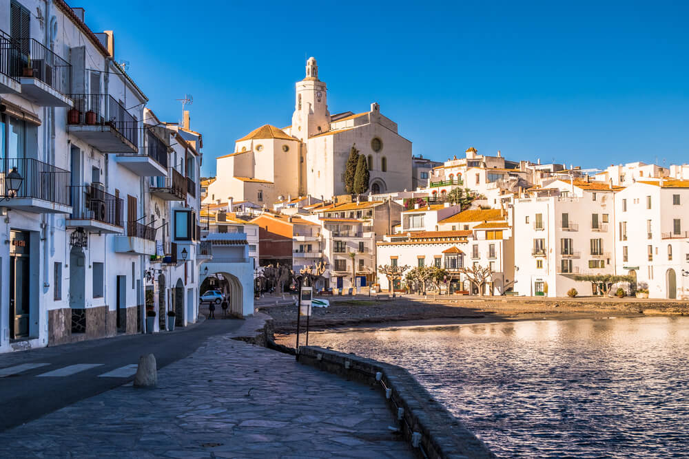 Things to do in the Costa Brava: Cobbled streets and white buildings by the sea in Cadaques