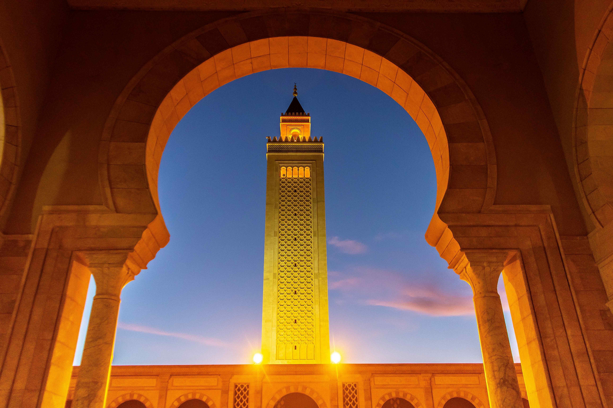 Things to do in Tunisia: An archway with a Mosque turret in the centre of the arch