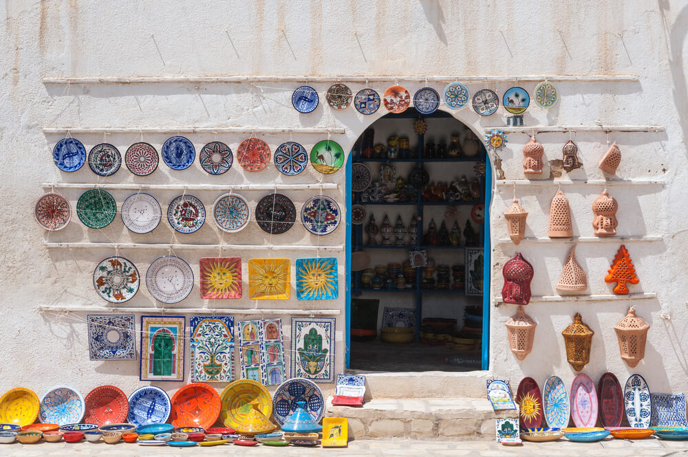 Djerba: A white store with its facade decorated with traditional Tunisian pottery