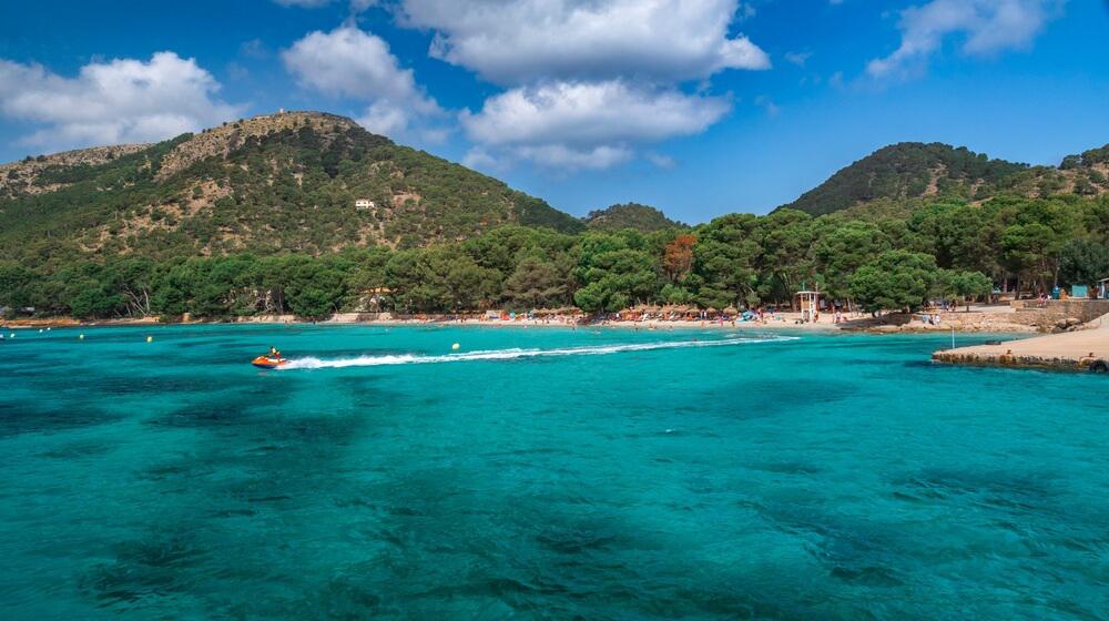 Formentor: A green, lush island with white sand seen from the sea