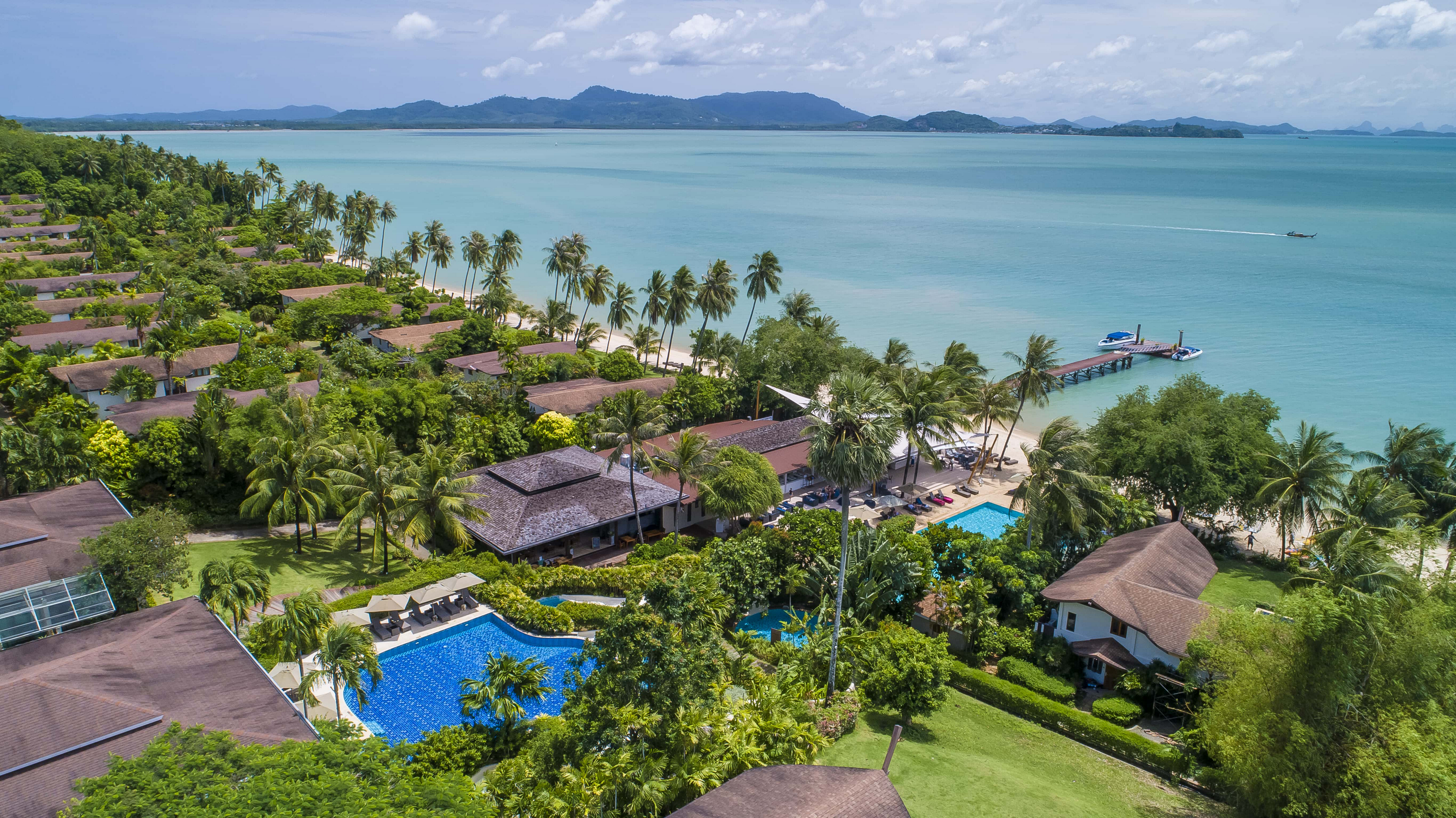 Christmas Holidays in the Sun: A green coastline dotted with bungalows overlooking the sea