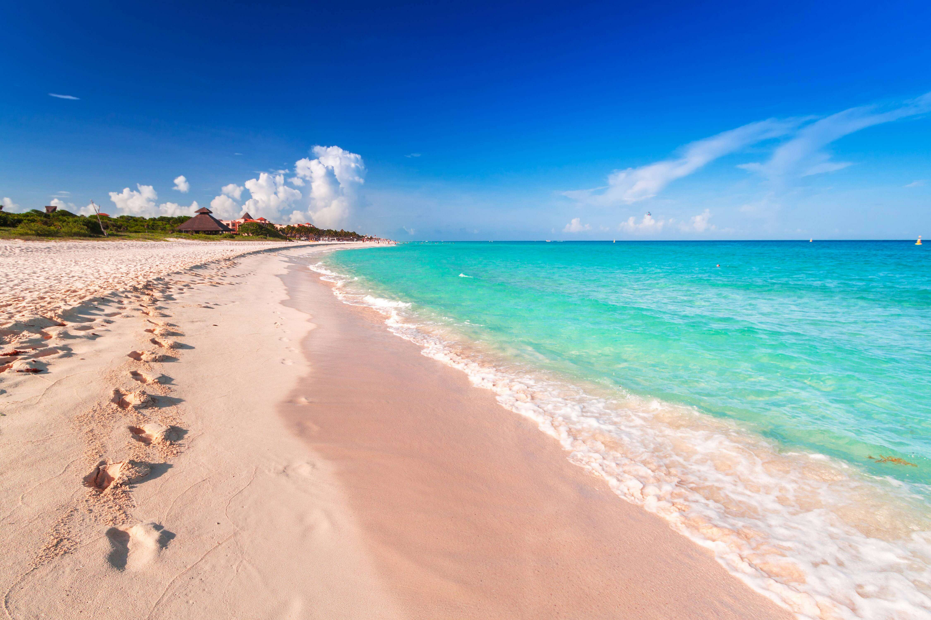 Playa del Carmen: Pink-tinted sands and blue ocean of an empty beach
