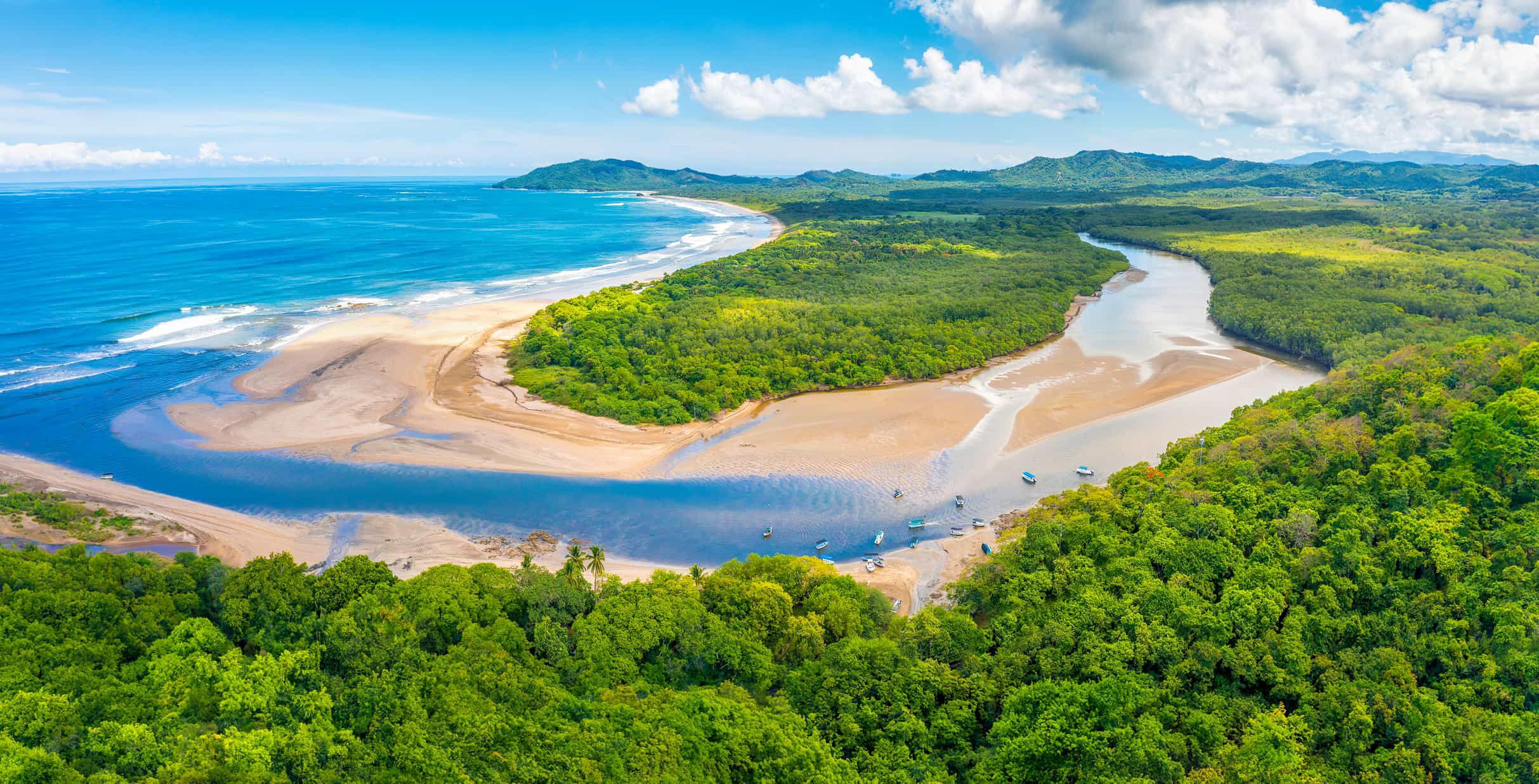 Tamarindo: A green rainforest and a vast, white coastline with blue ocean