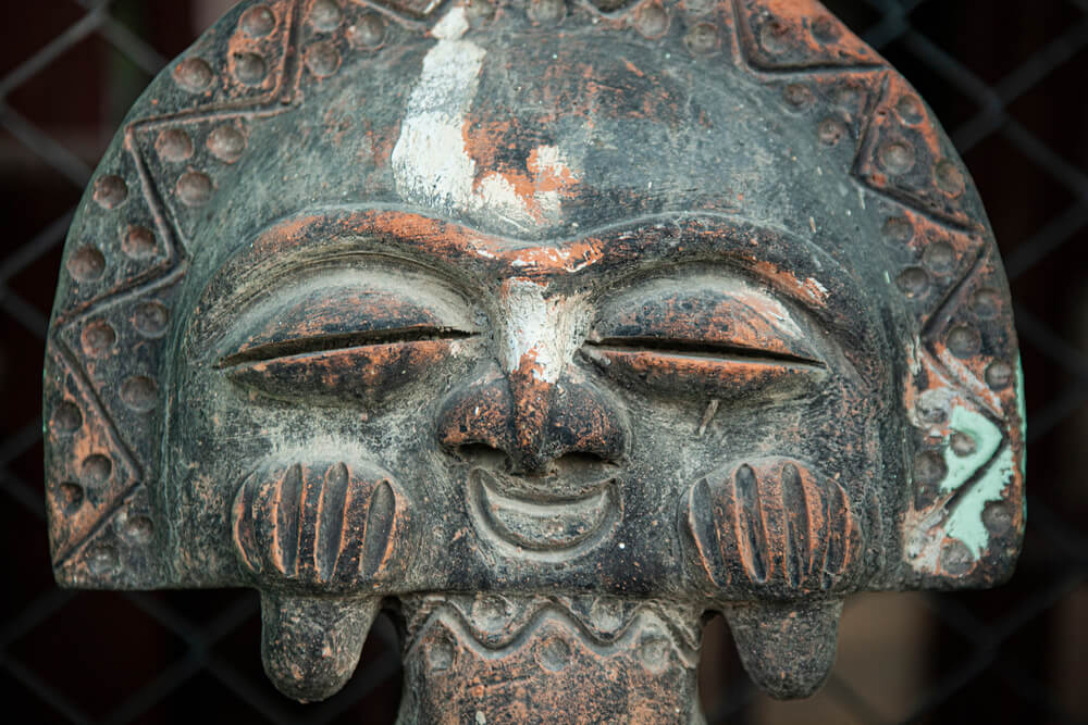 Cuban Culture: A grey stone chiselled sculpture of an indigenous face