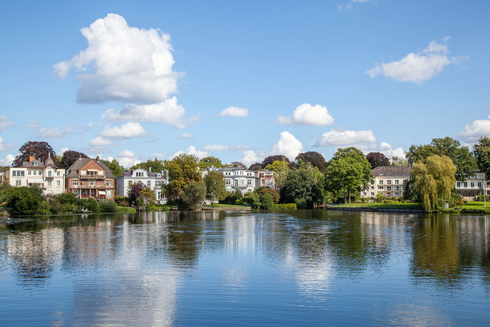 Aktivitäten in Hamburg: Bäume und Häuser am Ufer der Außenalster, ideal zum Kajakfahren.