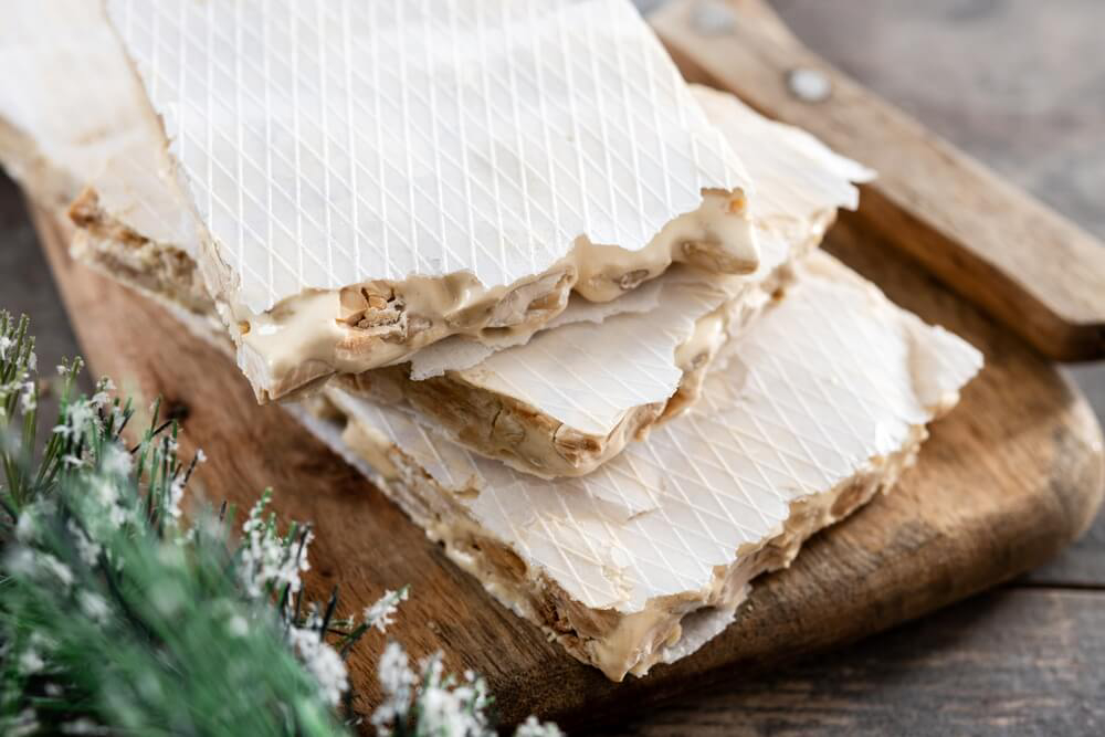 Spanish Christmas sweets: A wooden board with white nougat 