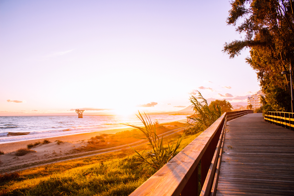 Things to do in Marbella: Sun setting on the boardwalk of the Paseo Marítimo in Marbella