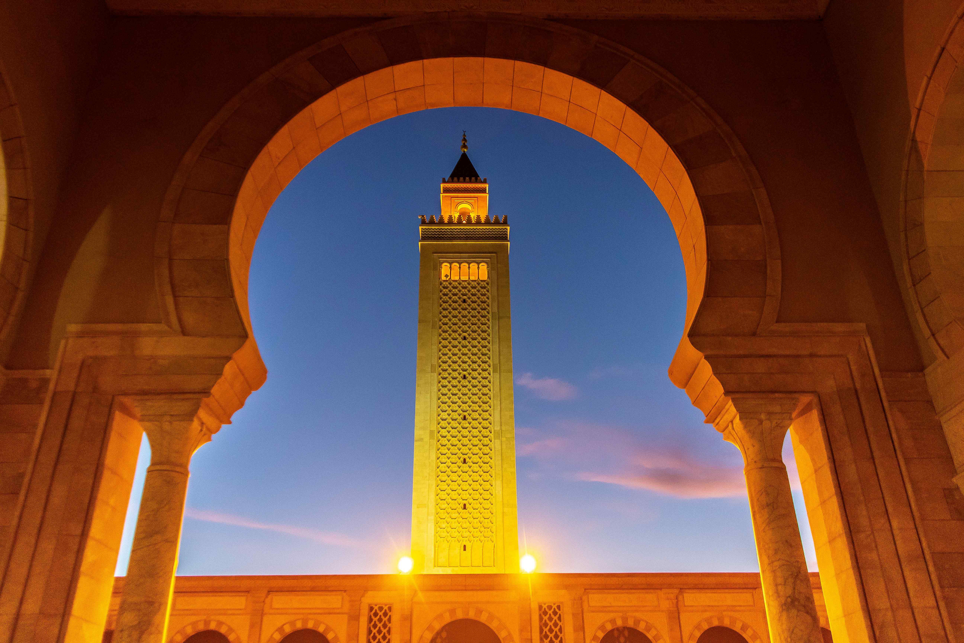 Things to do in Tunisia: An archway with a Mosque turret in the centre of the arch
